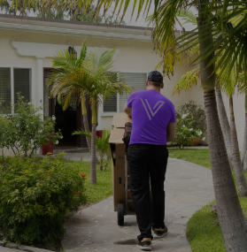 Mover delivering boxes to a residential home