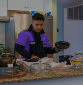Mover carefully packing kitchen dishware