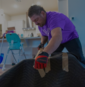 Mover wrapping and securing a mattress for a labor-only move